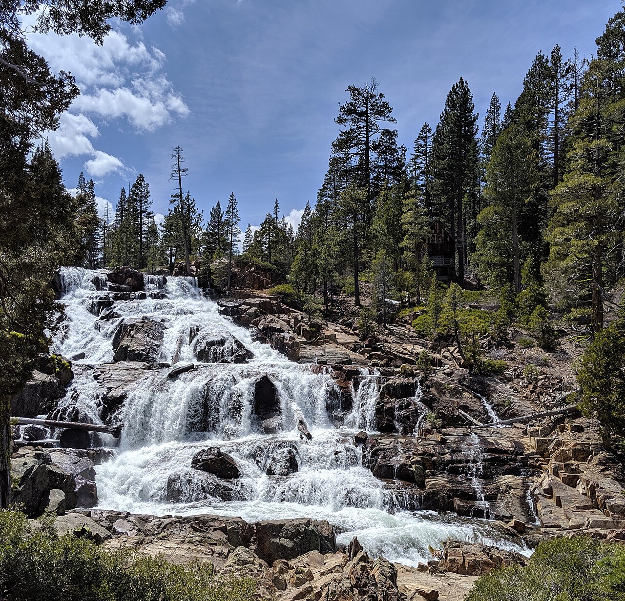 Broad whitewater flowing over stepped rocks at Glen Alpine Falls in May 2019