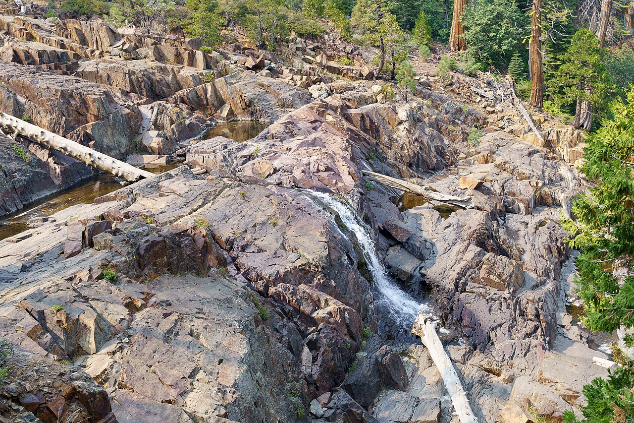A narrow cascade among exposed rocks at Lower Glen Alpine Falls in September 2020