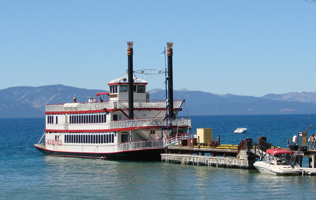 M.S. Dixie II at a dock, showing enclosed lower decks, an open upper deck and exterior stairs in September 2010.