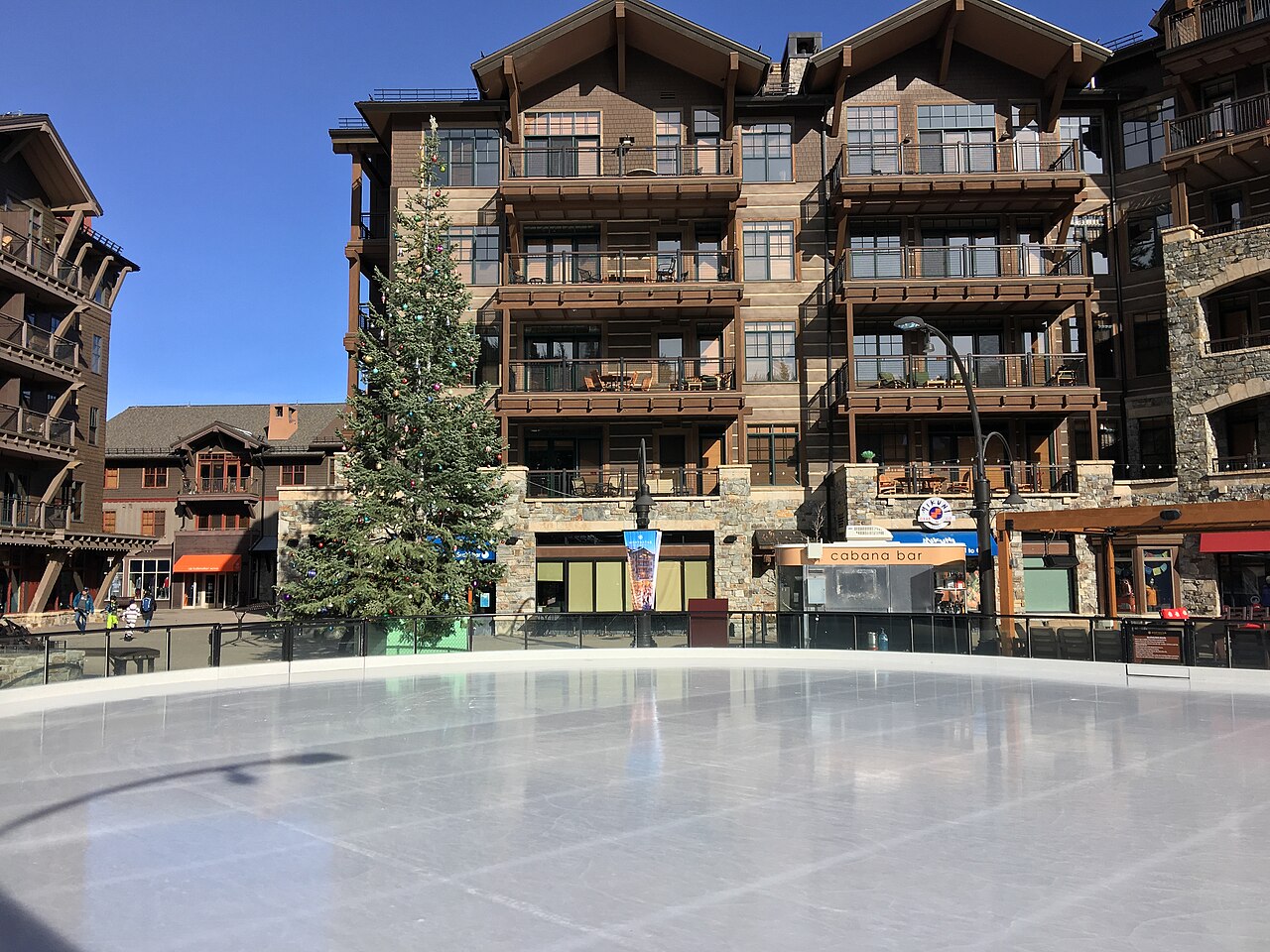 Northstar Village outdoor ice rink beside lodge buildings and a Christmas tree in November 2016